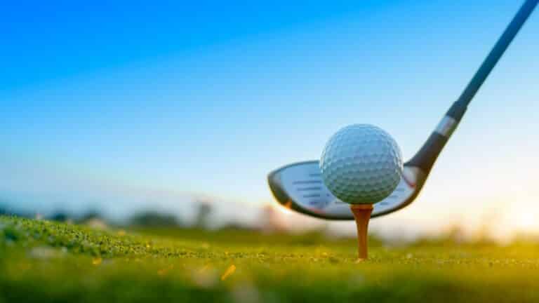 Golf,clubs,and,golf,balls,on,a,green,lawn,in