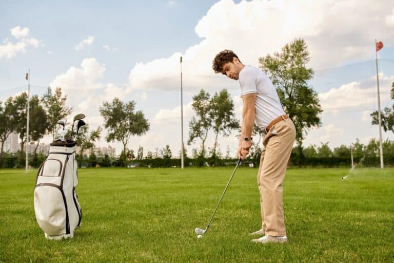 A,man,dressed,in,elegant,clothes,is,hitting,a,golf