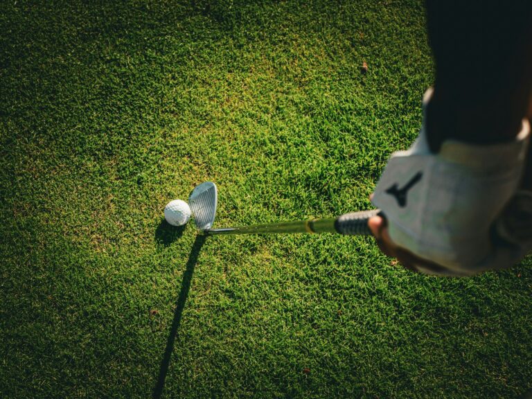 a person swinging a golf club