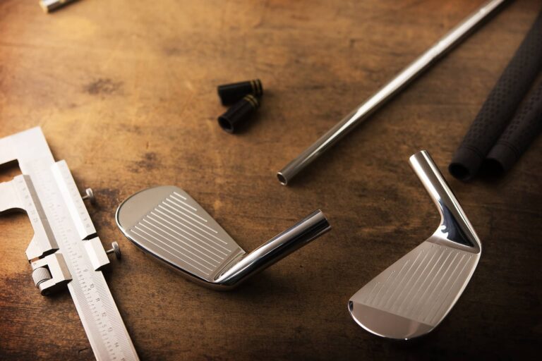 Clubmaker assembling a golf club with an iron head and steel shaft