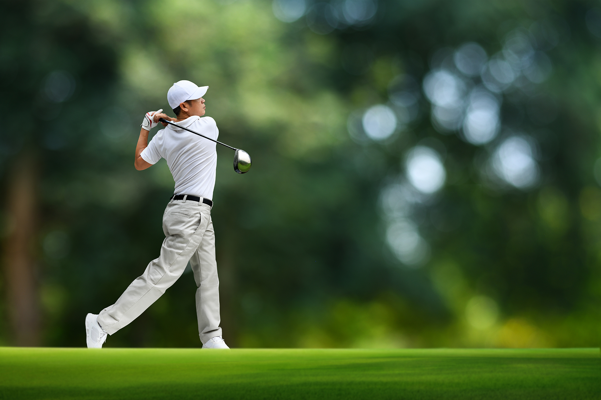Golfer finishing a driver swing on the course