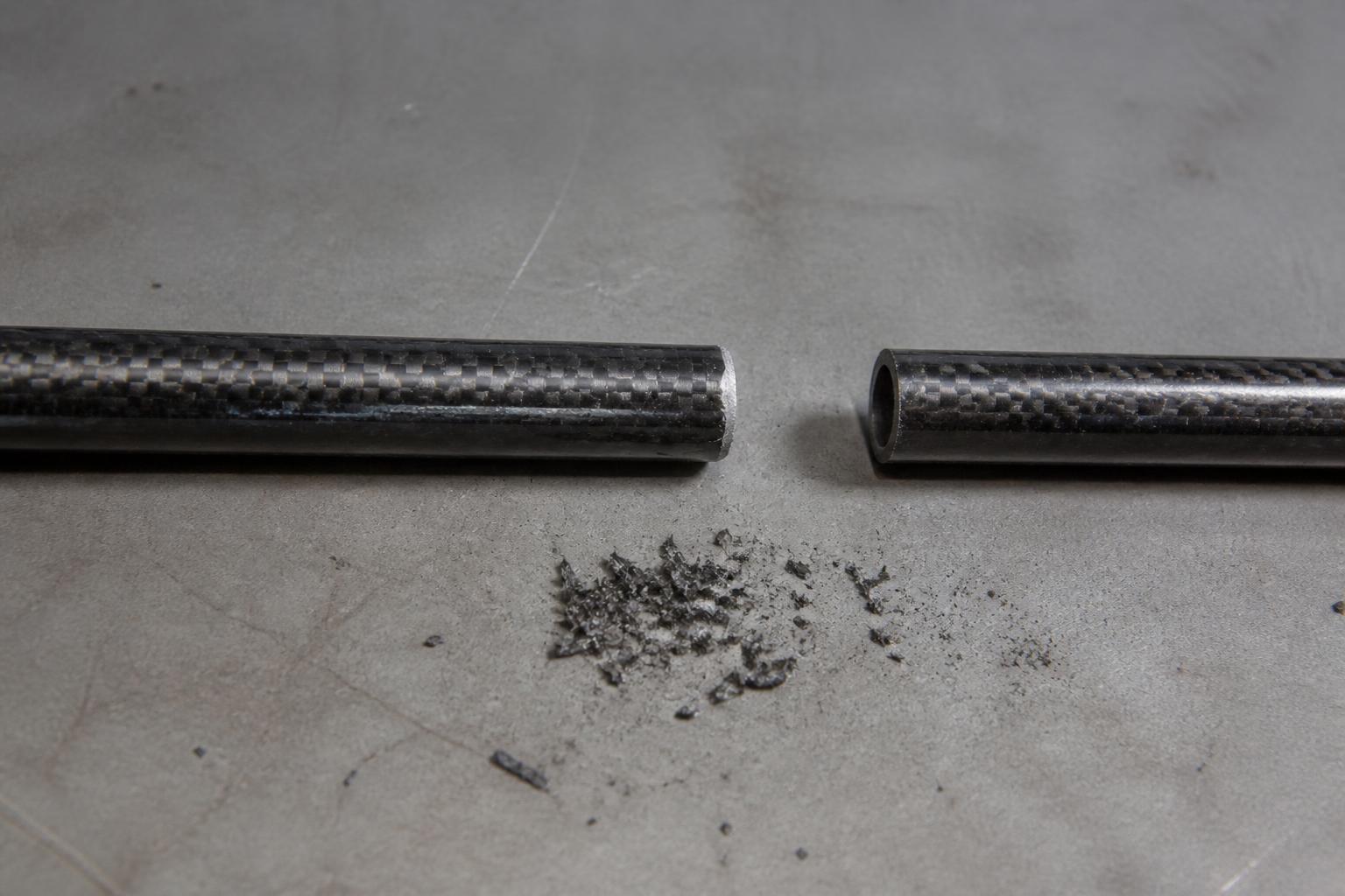 side-by-side comparison of two golf shaft tip ends resting on a neutral gray workshop surface, one freshly cut