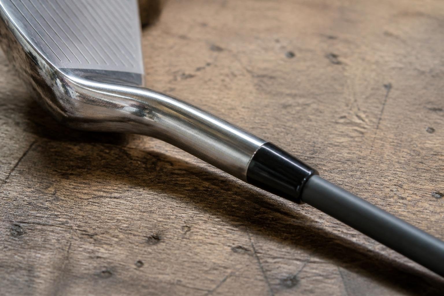 Black ferrule sitting flush on a graphite shaft above an iron hosel